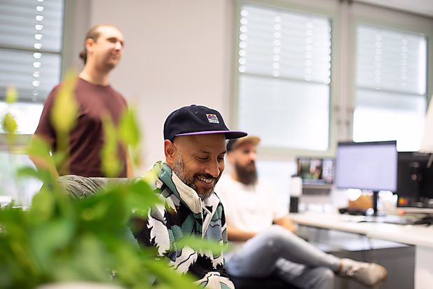 Kreatives Arbeiten im Büro – lockere Atmosphäre mit Pflanzen im Vordergrund.